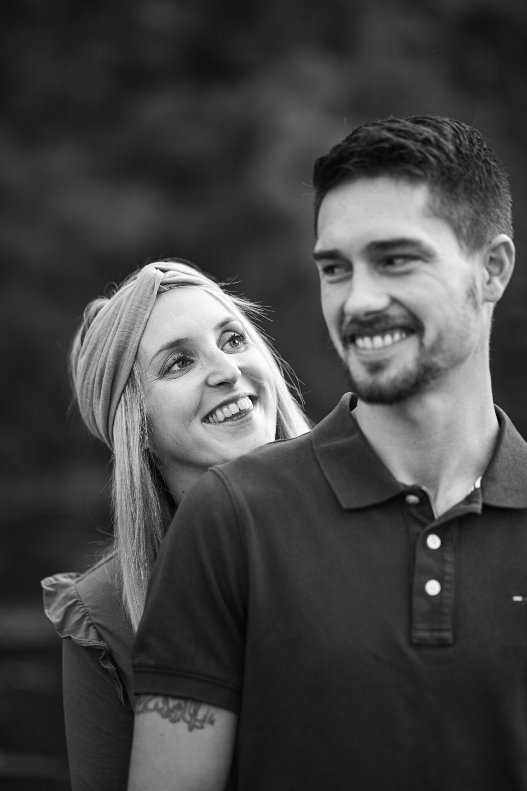 Couple souriant regardant au loin, portrait noir et blanc